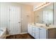 This bathroom has double sinks, lots of cabinet space, and wood look floors at 107 Kimeo Way, Garner, NC 27529