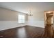 Chandelier lit dining room with wood-look floors and decorative wainscoting at 107 Kimeo Way, Garner, NC 27529