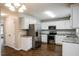 Modern kitchen featuring white cabinetry, stainless steel appliances, and granite countertops at 107 Kimeo Way, Garner, NC 27529