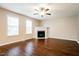 Bright living room features wood flooring, fireplace, and double windows at 107 Kimeo Way, Garner, NC 27529