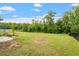 Expansive backyard with green grass, bordered by trees, with metal fence and some landscaping at 110 Gallery Park Dr, Franklinton, NC 27525