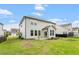 Exterior of home showcasing the back yard with a small patio area and light-colored siding at 110 Gallery Park Dr, Franklinton, NC 27525