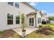 A home's exterior featuring a small patio area with sliding glass door and adjacent green space at 110 Gallery Park Dr, Franklinton, NC 27525