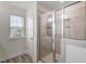 Bright bathroom featuring a glass-enclosed shower with tile surround and a window for natural light at 110 Gallery Park Dr, Franklinton, NC 27525