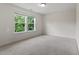 A well-lit bedroom with carpet, two windows overlooking a green space, and neutral paint at 110 Gallery Park Dr, Franklinton, NC 27525