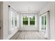 Dining area with large windows and sliding glass doors providing natural light and backyard views at 110 Gallery Park Dr, Franklinton, NC 27525