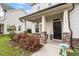 Inviting front porch with brick accents, decorative plants, and a black front door at 110 Gallery Park Dr, Franklinton, NC 27525