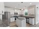 Bright kitchen featuring white cabinets, stainless steel appliances, granite countertops, and a kitchen island at 110 Gallery Park Dr, Franklinton, NC 27525
