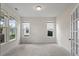 Empty living room featuring neutral walls and carpet and a lot of natural light through several windows at 110 Gallery Park Dr, Franklinton, NC 27525