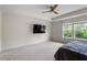 Main bedroom featuring a ceiling fan and a television at 110 Gallery Park Dr, Franklinton, NC 27525