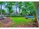 Large backyard with a pool, firepit, and a wooden privacy fence at 113 Fetzer Ct, Cary, NC 27513