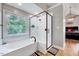 Bathroom features a glass shower, soaking tub, and view to the bedroom at 113 Fetzer Ct, Cary, NC 27513