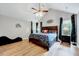 Primary bedroom features vaulted ceilings, hardwood floors, and large windows offering natural light at 113 Fetzer Ct, Cary, NC 27513