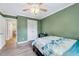 Bedroom with hardwood floors, ceiling fan, and ensuite bathroom at 113 Fetzer Ct, Cary, NC 27513