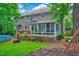 Back exterior of home with a deck, sunroom, above-ground pool, and lush greenery at 113 Fetzer Ct, Cary, NC 27513