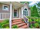 Inviting front porch with brick steps, white railings, and decorative wreath on the front door at 113 Fetzer Ct, Cary, NC 27513