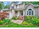 A well-maintained two-story home with a lush landscaped yard, inviting front porch, and attached garage at 113 Fetzer Ct, Cary, NC 27513