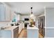 Stylish kitchen featuring white cabinetry, stainless steel appliances, and ample counter space for cooking at 113 Fetzer Ct, Cary, NC 27513