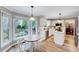 Eat-in kitchen features an island, stainless steel appliances, and large windows offering abundant natural light at 113 Fetzer Ct, Cary, NC 27513