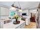 Bright kitchen with white cabinets, subway tile backsplash, stainless steel appliances, and an island at 113 Fetzer Ct, Cary, NC 27513