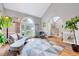 Spacious living area featuring tall windows, hardwood flooring, and a stairway with metal railings at 113 Fetzer Ct, Cary, NC 27513