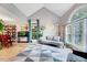 Open living room featuring tall windows, a vaulted ceiling, and light hardwood flooring at 113 Fetzer Ct, Cary, NC 27513
