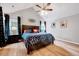 Vaulted ceiling bedroom with hardwood floors, ceiling fan, and dark wood furniture at 113 Fetzer Ct, Cary, NC 27513