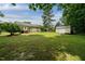 Expansive, well-manicured backyard featuring a large grassy lawn, a utility shed and access stairs to the home at 117 Rack Ct, Willow Springs, NC 27592