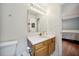 Bright bathroom features a white vanity with a solid surface counter and view to an adjacent bedroom at 117 Rack Ct, Willow Springs, NC 27592
