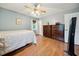 Bedroom featuring wood-look flooring, two windows and light blue walls at 117 Rack Ct, Willow Springs, NC 27592