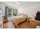 Bedroom showcasing large window, wood-look floors, and neutral color palette at 117 Rack Ct, Willow Springs, NC 27592