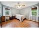 Cozy bedroom features wood-look flooring, light blue walls, and two windows at 117 Rack Ct, Willow Springs, NC 27592