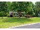 Charming home with mature trees, manicured lawn, and lush landscaping creating a serene and inviting curb appeal at 117 Rack Ct, Willow Springs, NC 27592