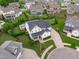 An aerial view highlighting a modern home with a spacious yard and a well-manicured lawn in a friendly neighborhood at 120 Hazel Alder Ct, Holly Springs, NC 27540