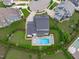 Stunning aerial view of a home featuring a pristine backyard pool and manicured landscaping at 120 Hazel Alder Ct, Holly Springs, NC 27540