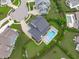 An aerial shot showcases a beautiful home with a backyard pool and a meticulously landscaped yard at 120 Hazel Alder Ct, Holly Springs, NC 27540
