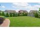 A spacious backyard featuring a lush lawn, landscaping, and a soccer net, perfect for outdoor activities at 120 Hazel Alder Ct, Holly Springs, NC 27540