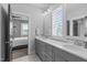 Bright bathroom with double vanity, white countertop, and plantation shutters on the windows at 120 Hazel Alder Ct, Holly Springs, NC 27540