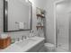 Well-lit bathroom with a sleek vanity, framed mirror, and a glass-enclosed shower at 120 Hazel Alder Ct, Holly Springs, NC 27540