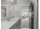 A bathroom features a single vanity and an open view to the living room area at 120 Hazel Alder Ct, Holly Springs, NC 27540