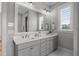 Bright bathroom with double vanity, white countertop, and large mirror for ample space at 120 Hazel Alder Ct, Holly Springs, NC 27540
