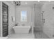 A modern bathroom showcases a luxurious bathtub and a glass-enclosed shower with marble tile at 120 Hazel Alder Ct, Holly Springs, NC 27540
