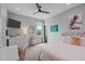 Cozy bedroom with ceiling fan, window views, and a stylish desk setup at 120 Hazel Alder Ct, Holly Springs, NC 27540