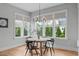 Cozy breakfast nook with large windows and modern chandelier at 120 Hazel Alder Ct, Holly Springs, NC 27540