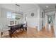 Elegant dining room featuring hardwood floors, wainscoting, and a modern chandelier at 120 Hazel Alder Ct, Holly Springs, NC 27540
