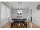 Chic dining room with a dark wood table set, light walls and modern lighting fixture at 120 Hazel Alder Ct, Holly Springs, NC 27540
