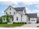 Charming two-story home with white siding, a well-manicured lawn, and a welcoming front porch at 120 Hazel Alder Ct, Holly Springs, NC 27540