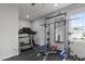Home gym equipped with treadmill, bike, and weightlifting equipment for fitness enthusiasts at 120 Hazel Alder Ct, Holly Springs, NC 27540