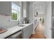 Bright kitchen with gray cabinets, white countertops, and hardwood floors with an open layout at 120 Hazel Alder Ct, Holly Springs, NC 27540