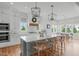 Spacious kitchen with island seating, modern lighting, and stainless steel appliances at 120 Hazel Alder Ct, Holly Springs, NC 27540